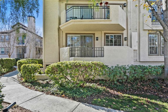 Front view of a multi-story residential building with balconies.