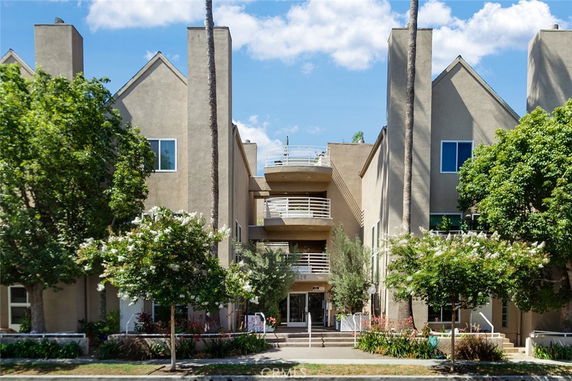 Front view of a multi-story residential building with balconies.