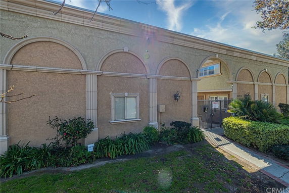 Front view of a building with arched windows and a gated entrance.