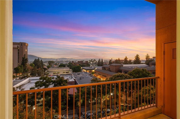 Panoramic view of cityscape during sunset from a balcony.