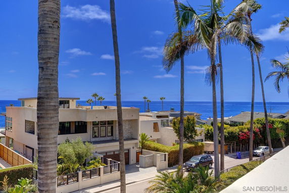 View of residential area with ocean in the background.