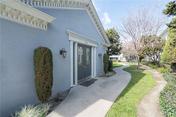 Front view of a house with a double door entry and ornamental trim.