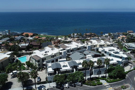 Aerial view of residential buildings near the ocean.