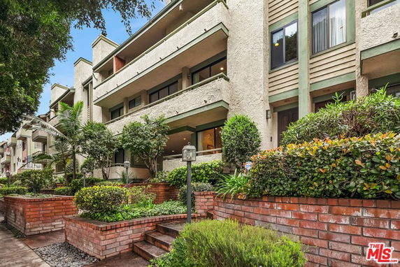 Front view of a multi-story residential building with balconies.
