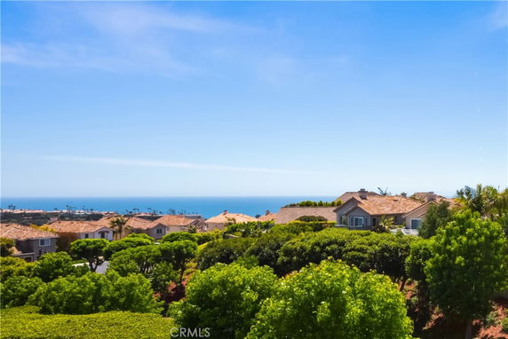 Panoramic view of houses with ocean in the background.