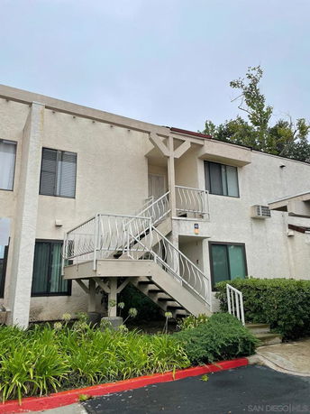 Front view of a two-story building with an external staircase.