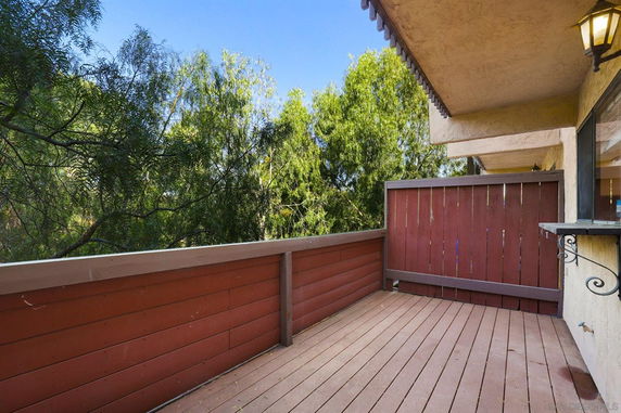 View from a wooden deck with surrounding trees.