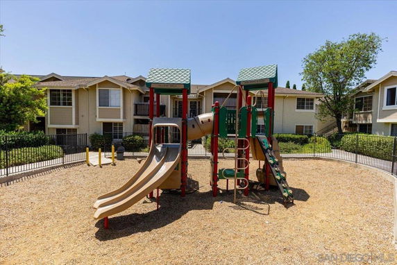 Outdoor play area with a slide and climbing structure.