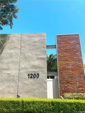 Front view of a modern building with a mix of concrete and brick walls.