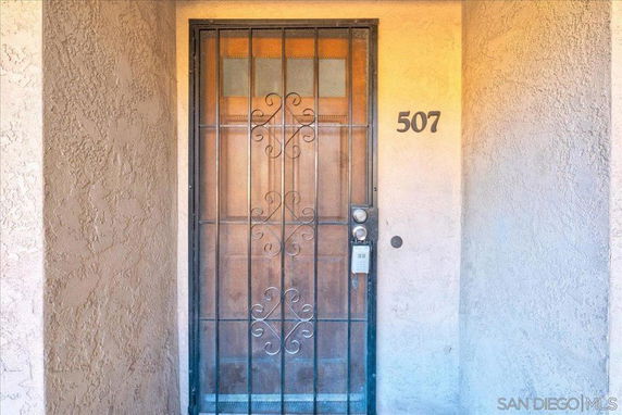 Front view of a house entrance with a metal security door and the number 507.