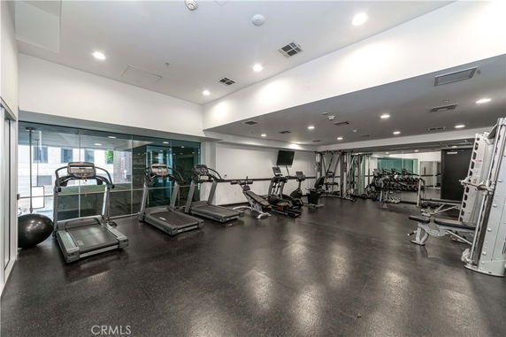 Interior view of a gym with exercise equipment like treadmills and weight machines.
