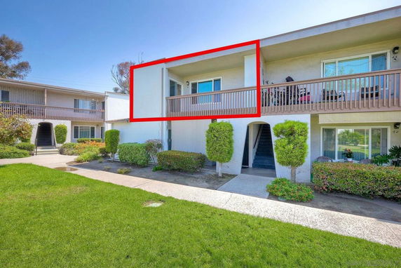 Front view of a two-story apartment building with a balcony.