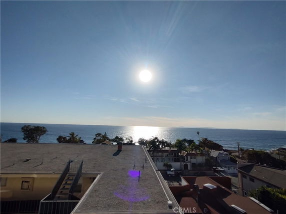 Panoramic view of an ocean and surrounding coastal area from a rooftop.
