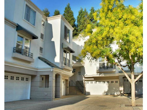 Front view of a multi-story residential building with garages.