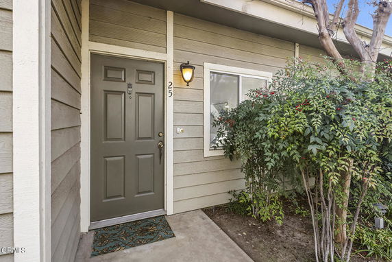 Front view of a house with a single door and a small window.