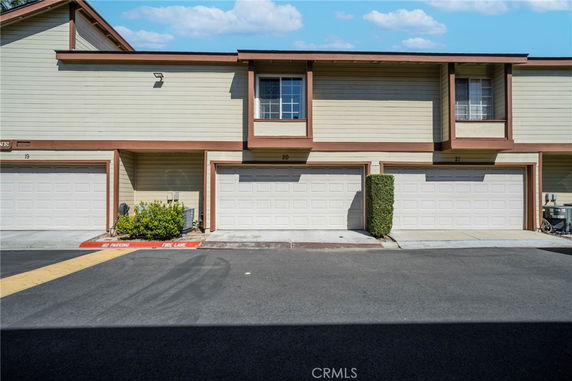 Front view of a two-story townhouse with a double garage.
