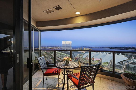 View from a balcony overlooking a city skyline and water.