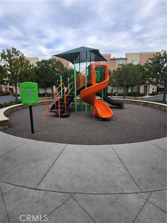 Playground with slides and climbing structures in an outdoor area.