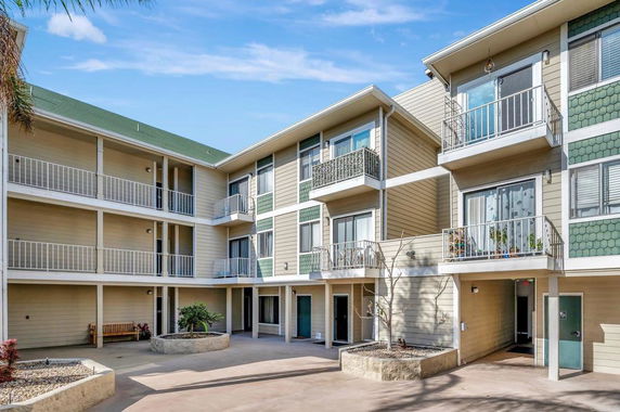 View of a multi-story residential building with balconies.