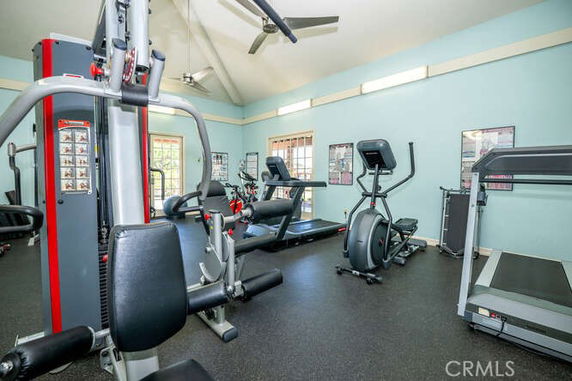 Interior view of a gym with exercise equipment including treadmills and elliptical machines.