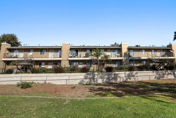 Front view of a two-story apartment building with balconies.