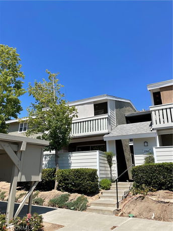 Front view of a two-story residential building with a balcony.