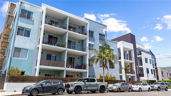Front view of a multi-story apartment building with balconies.