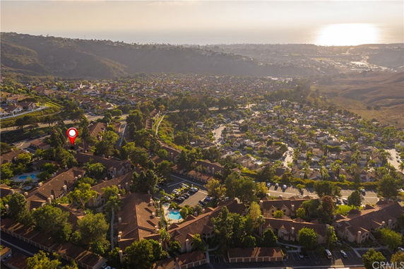 Panoramic view of a residential area with multiple houses and a road network.