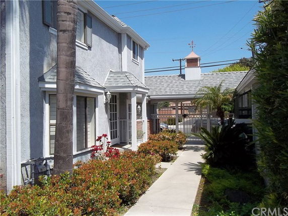 Front view of a two-story house with a path leading to the entrance.