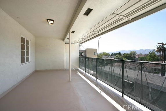 Covered balcony with a view of surrounding areas.