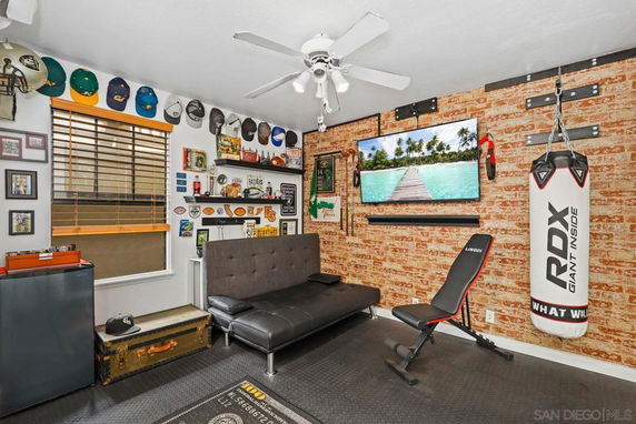 Indoor room with exercise equipment and sports memorabilia on display.