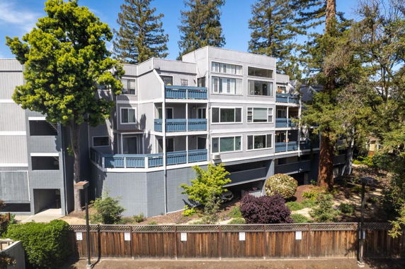 Front view of a multi-story residential building with balconies.