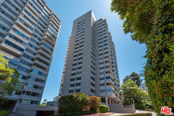 Front view of a multi-story residential building with balconies.