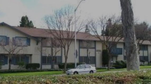 Front view of a two-story residential building with a pitched roof.