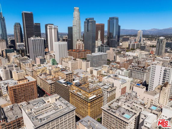 Wide angle view of city skyline with numerous skyscrapers and buildings.