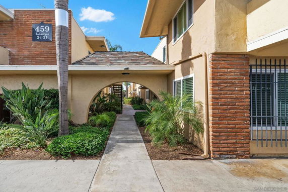 Front view of a two-story apartment building with archway entrance.