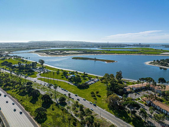 Wide angle view of a scenic area with a body of water and surrounding green spaces.