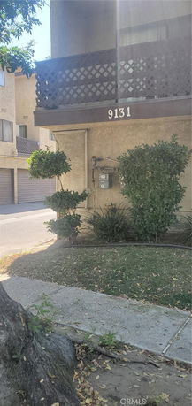 Exterior view of a building with a balcony and address number 9131.