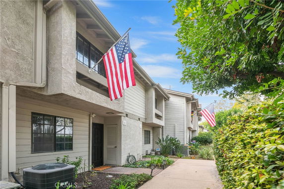 Front view of a multi-story building with American flags.
