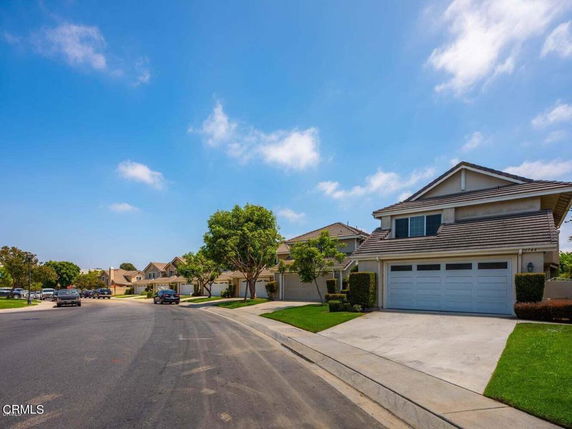 Street view with houses featuring front facades and driveways.
