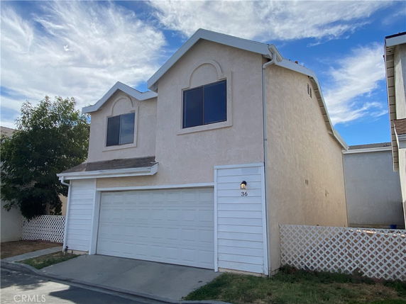 Front view of a two-story house with a garage.