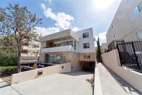 Front view of a modern multi-story building with balconies.
