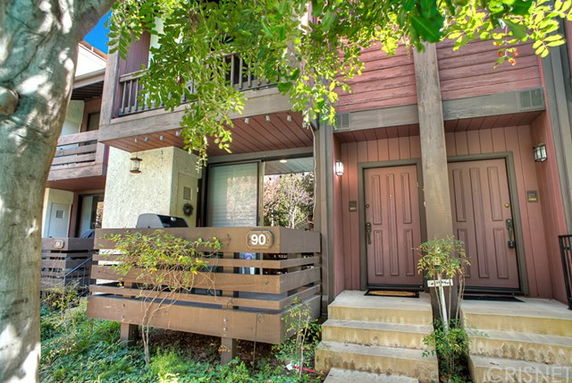 Front view of a two-story building with balconies and entrance steps.