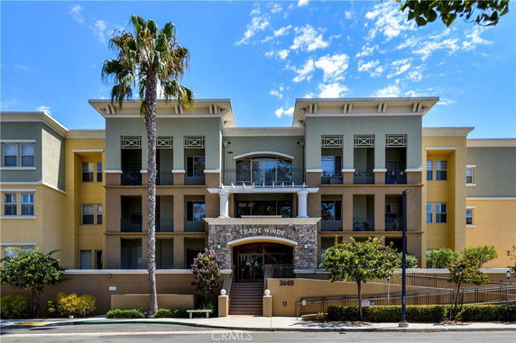 Front view of a multi-story residential building with a central entrance.
