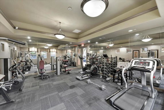 Indoor gym facility with exercise equipment and mirrors.