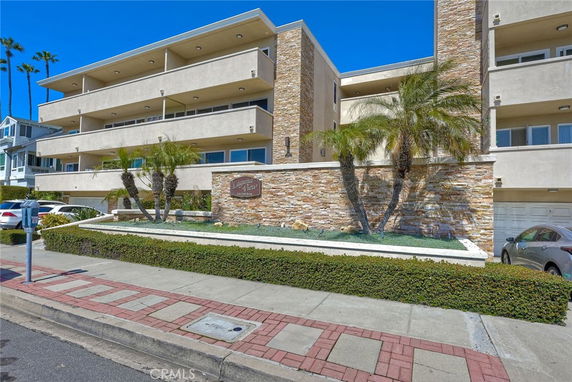 Front view of a multi-story building with balconies and stone accents.