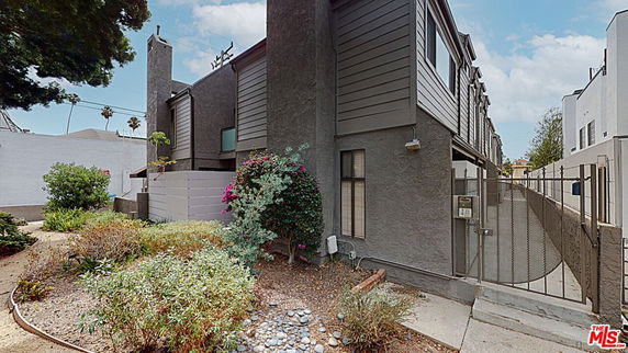 Front view of a two-story building with a gated entrance.
