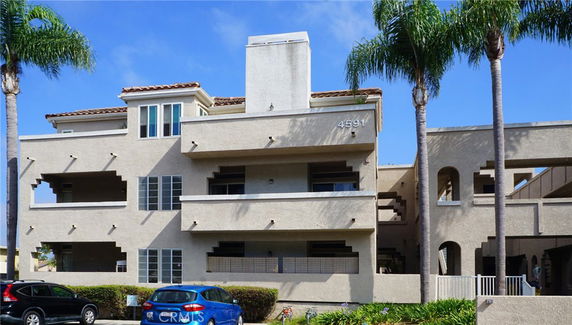 Front view of a multi-story residential building with balconies.