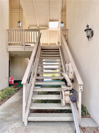 Front view of a building entrance with an outdoor staircase.