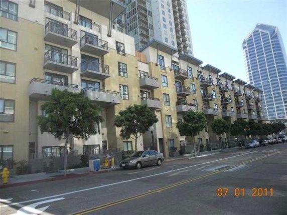 Front view of a multi-story apartment building with balconies.